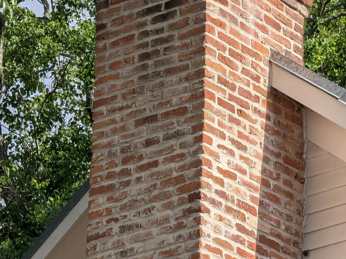 Chimney on an asphalt shingle roof in Central Texas, the most common source of a ceiling stain several feet downhill of it