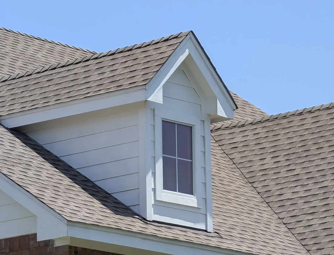 Dormer on a Central Texas roof showing the headwall above the lower slope and the sidewalls beside it