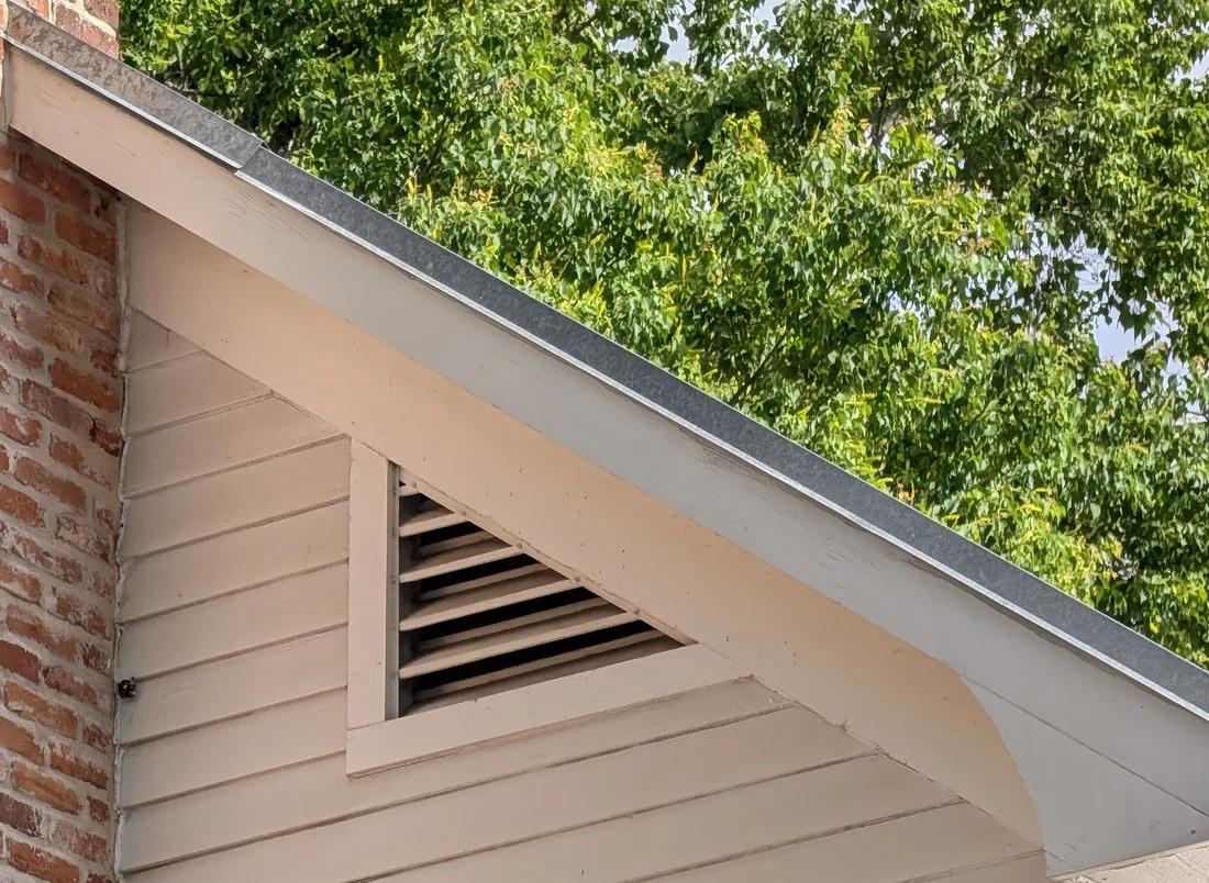 Gable end and rake edge of a Central Texas home, where wind uplift concentrates