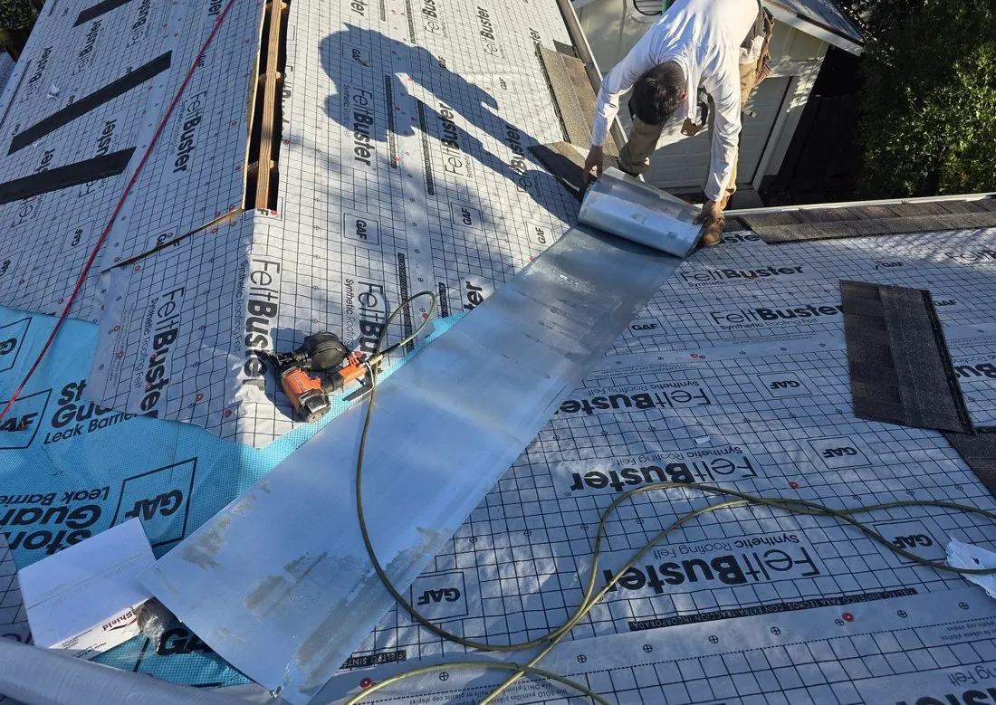 Open valley metal being laid over synthetic underlayment on a Central Texas reroof