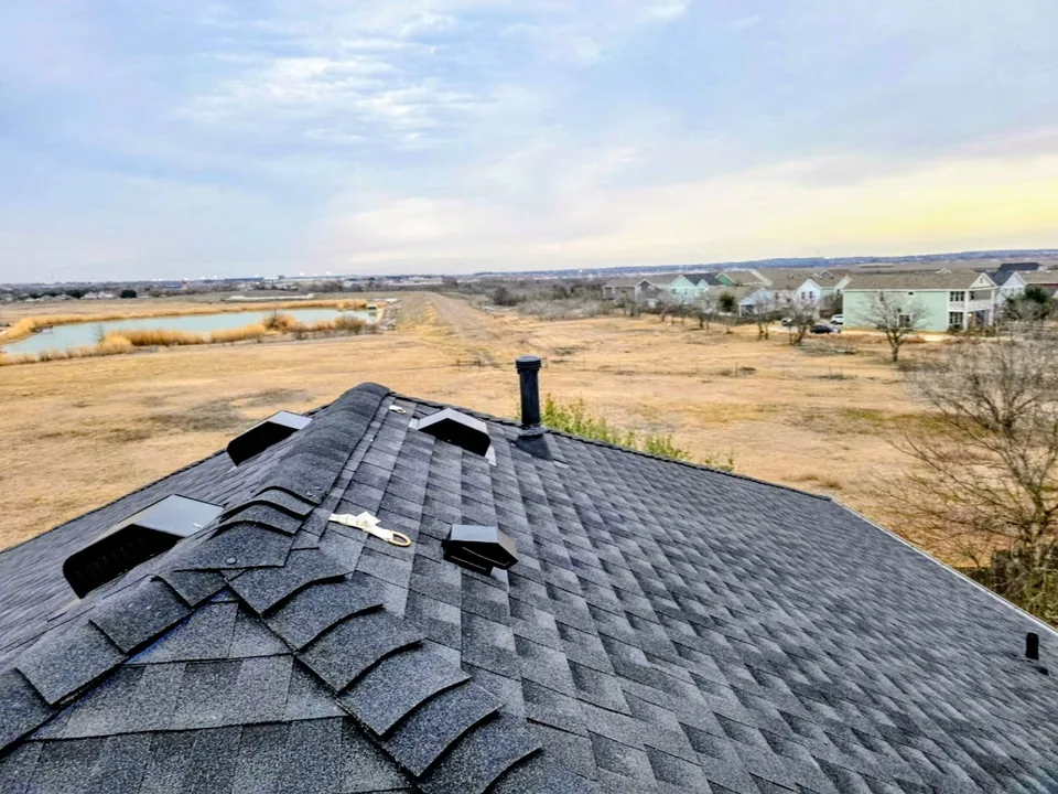 Box vents and ridge cap shingles near the roof peak