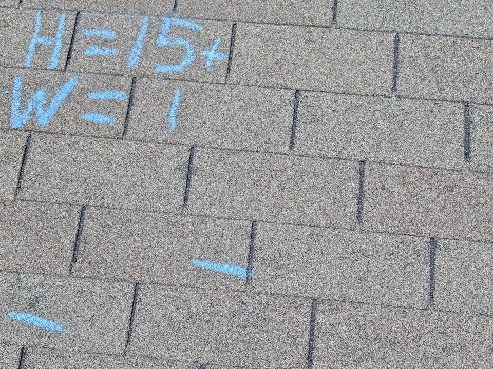 Blue chalk tally reading H=15+ and W=1 written on shingles in a test area