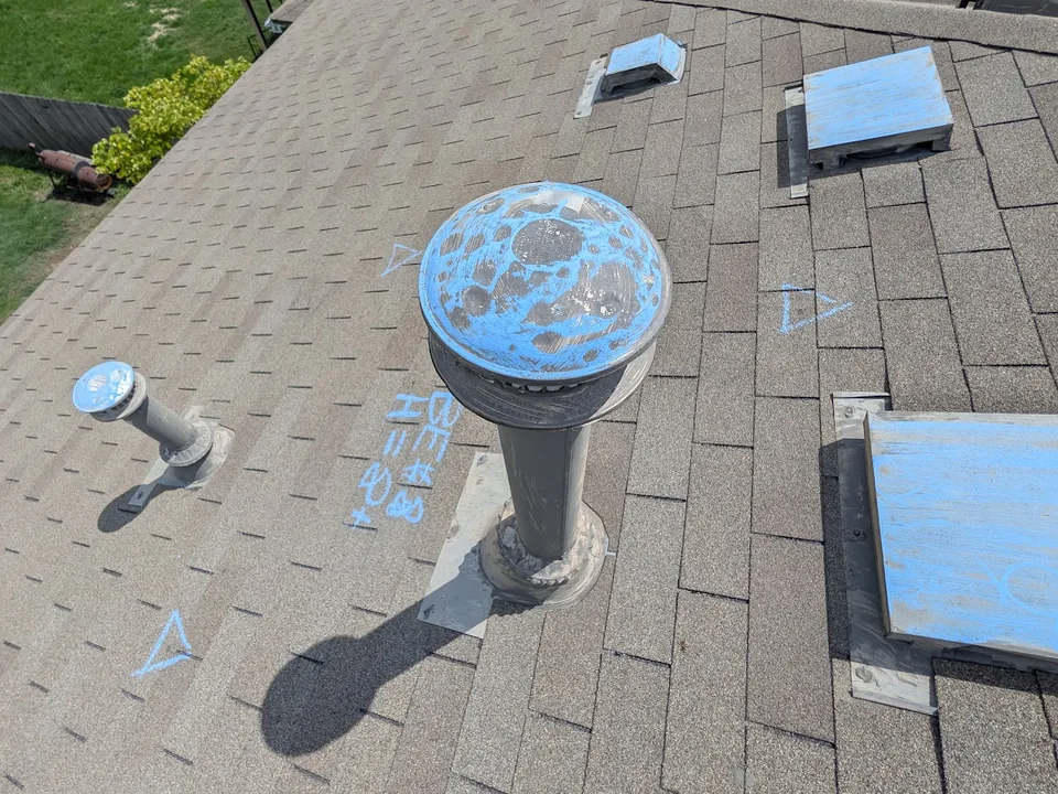 Roof slope during an inspection with chalked vents and chalk marks on shingles