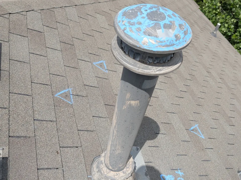 Metal vent cap rubbed with blue chalk to show dents