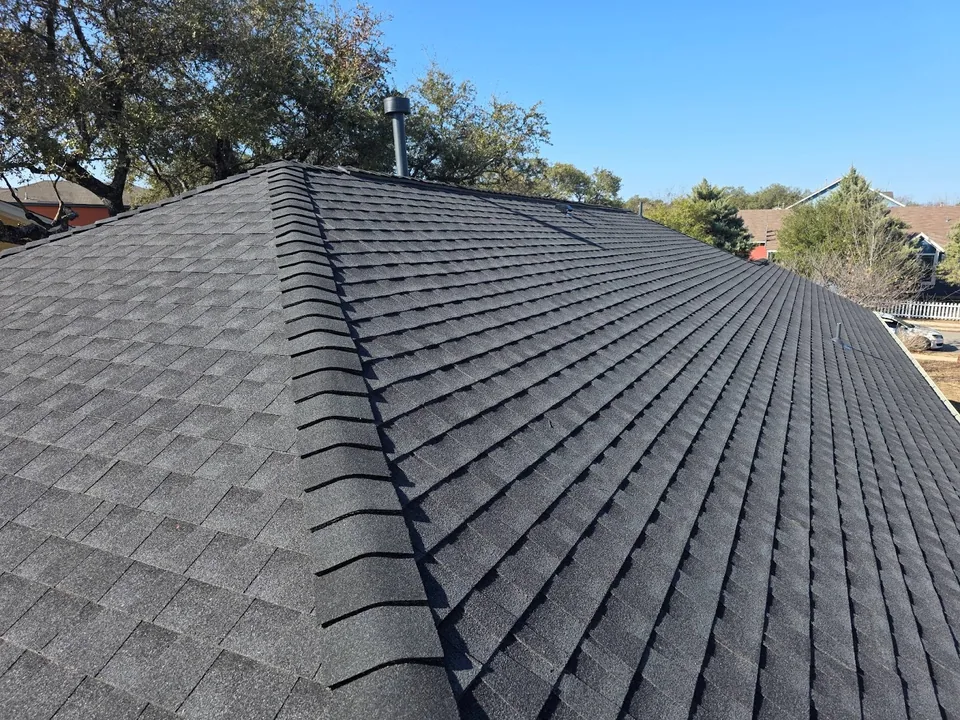 Hip cap running up a charcoal architectural shingle roof
