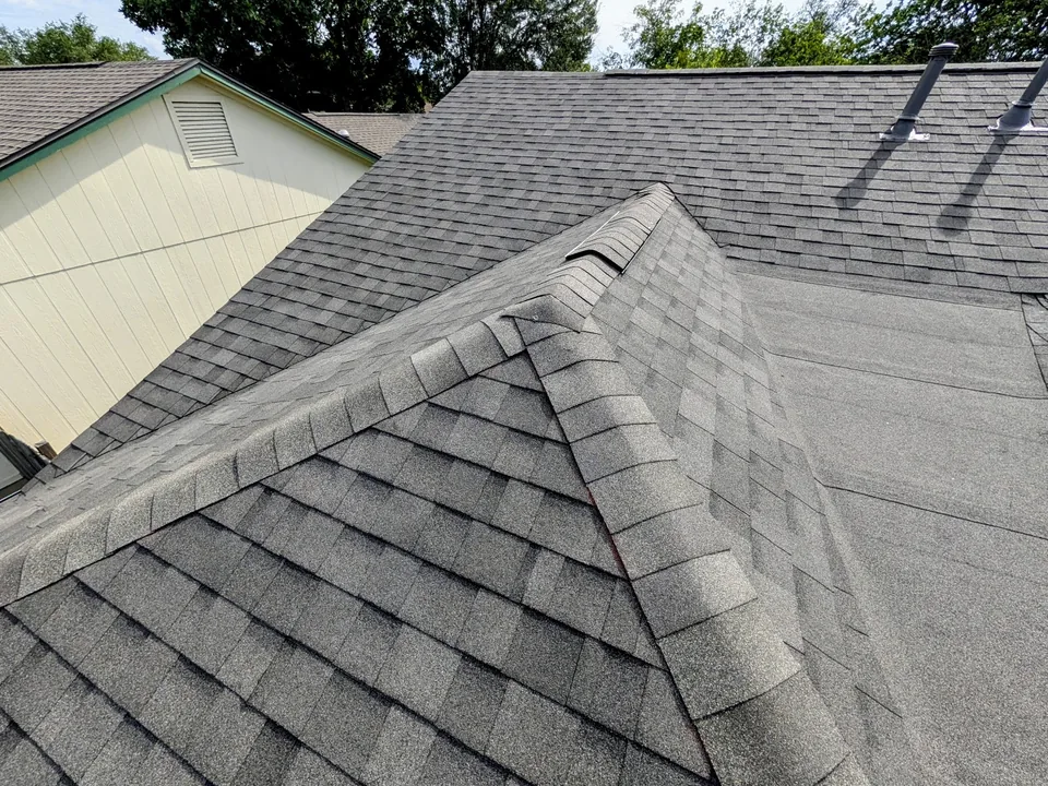 Hip cap shingles beside a low-slope section