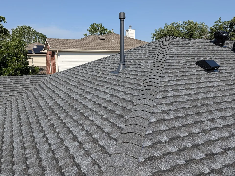 Hip cap shingles, a pipe vent and a box vent on a shingle roof