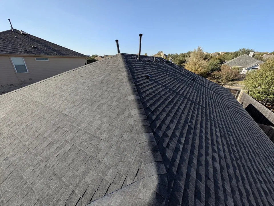 A hip line on a dark shingle roof