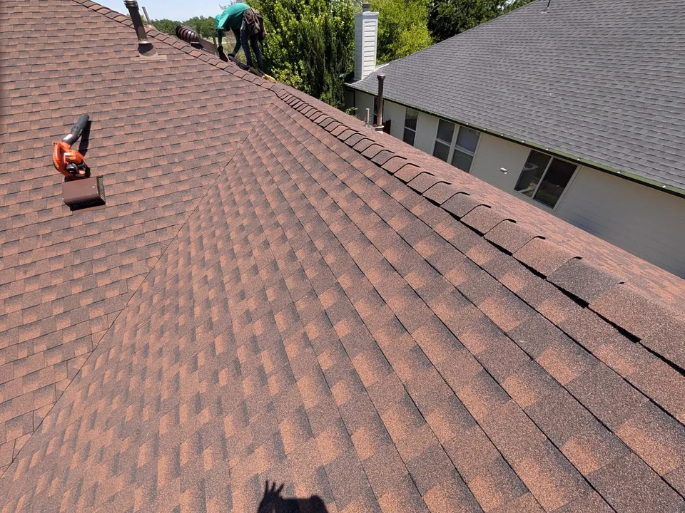 New red blend shingles with the crew working near the ridge