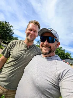 David from The Roof Shepherd reviewing roofing documentation with an Austin homeowner after a consultation