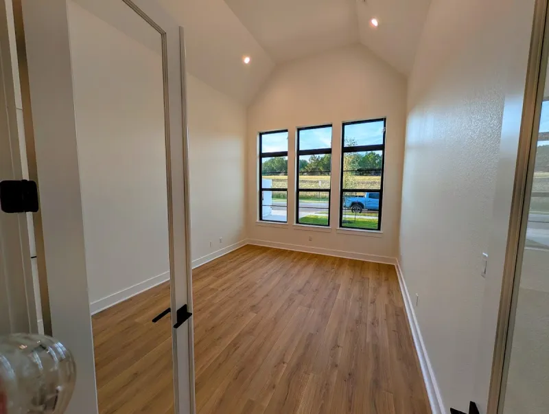 Finished room with white painted walls, wood-look flooring, and natural light in Georgetown, Texas.
