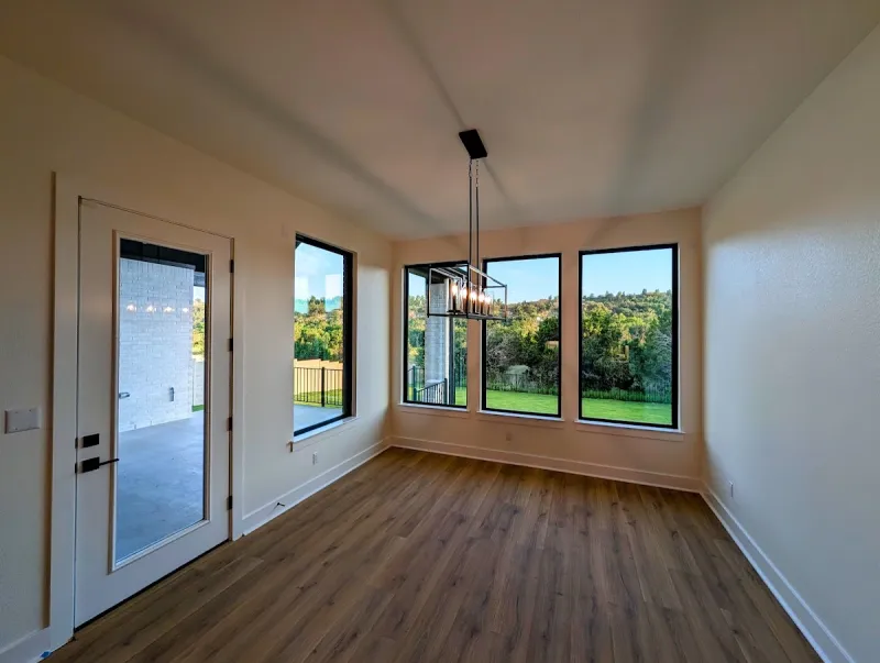 Finished dining room with painted walls, large windows, and natural light in Georgetown, Texas.